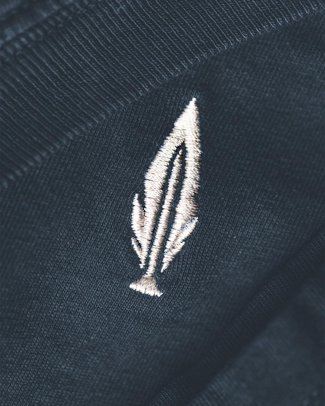 Feather and Hide logo on a blue tshirt