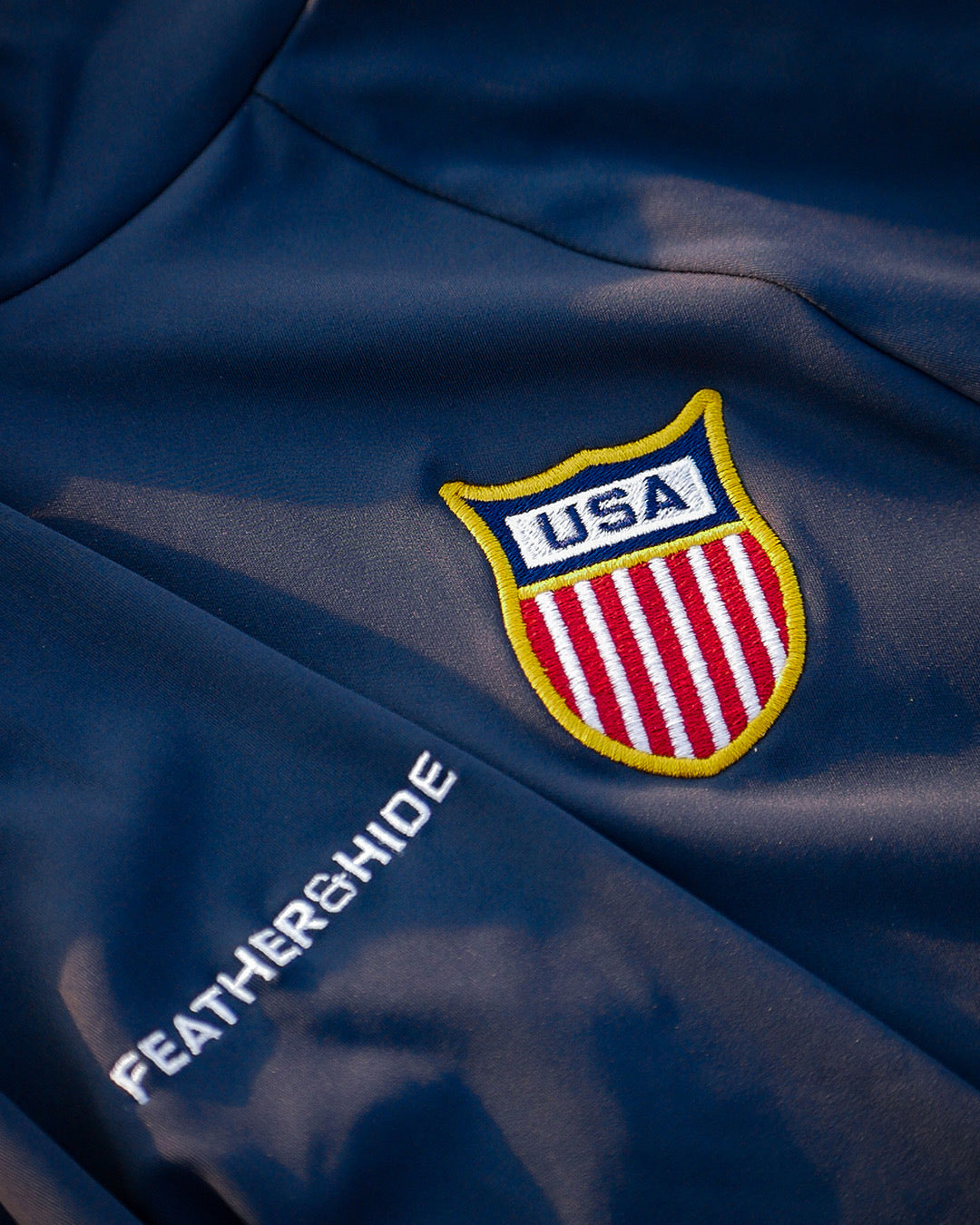 USA logo on a blue fabric with 'Feather and Hide' branding.