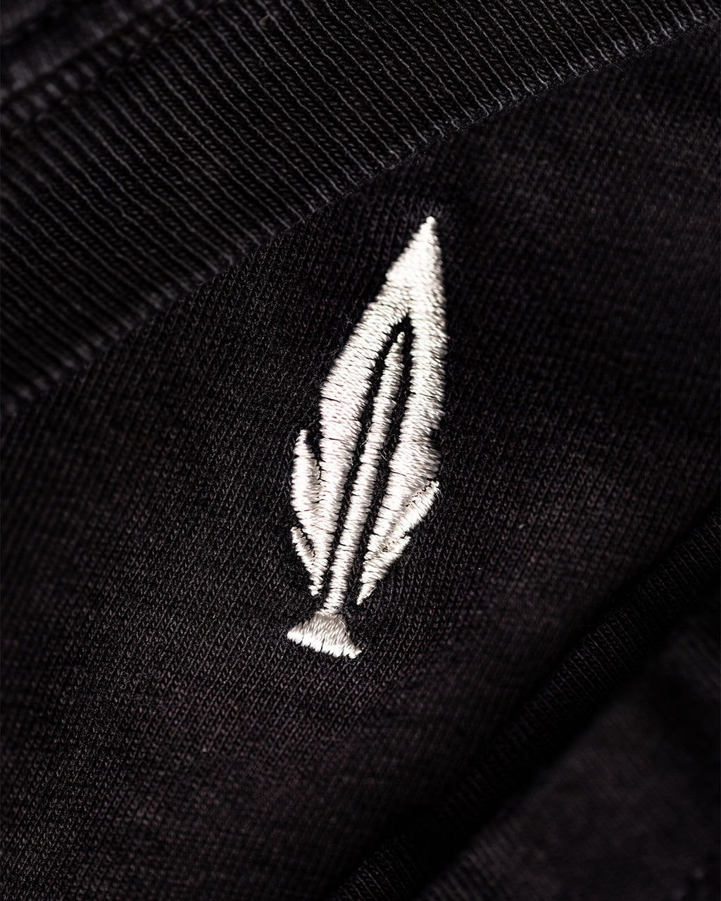 Feather and Hide logo on a black t shirt