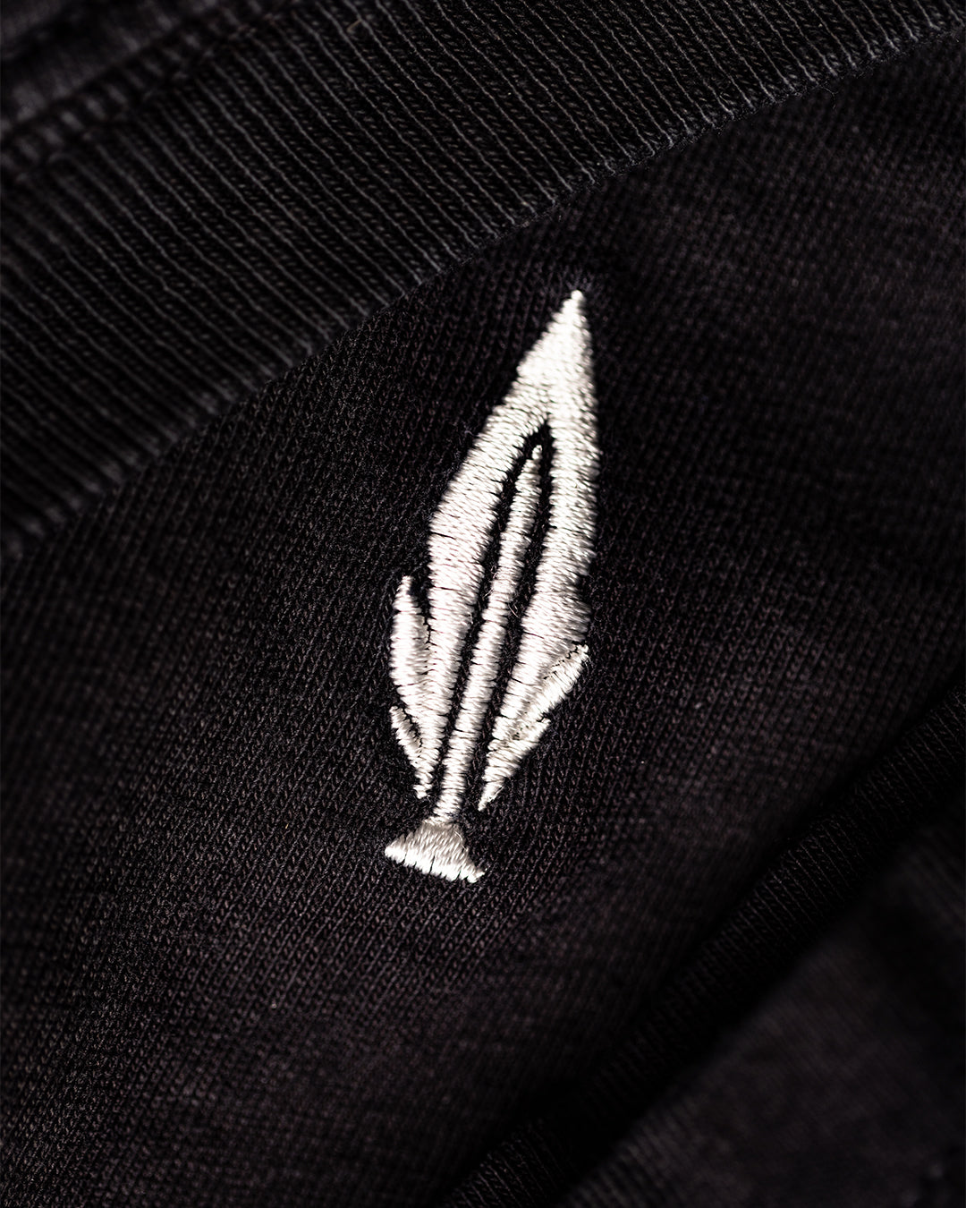 Feather and Hide logo on a black t shirt