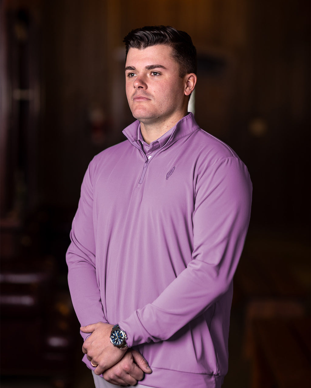man wearing a feather and hide golf quarter zip