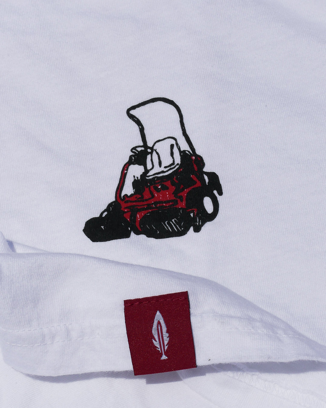 white tshirt with a lawn mower design by feather and hide
