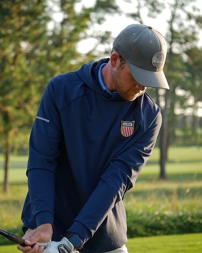 Golfer in a Feather and Hide golf hoodie with a limited edition USA patch