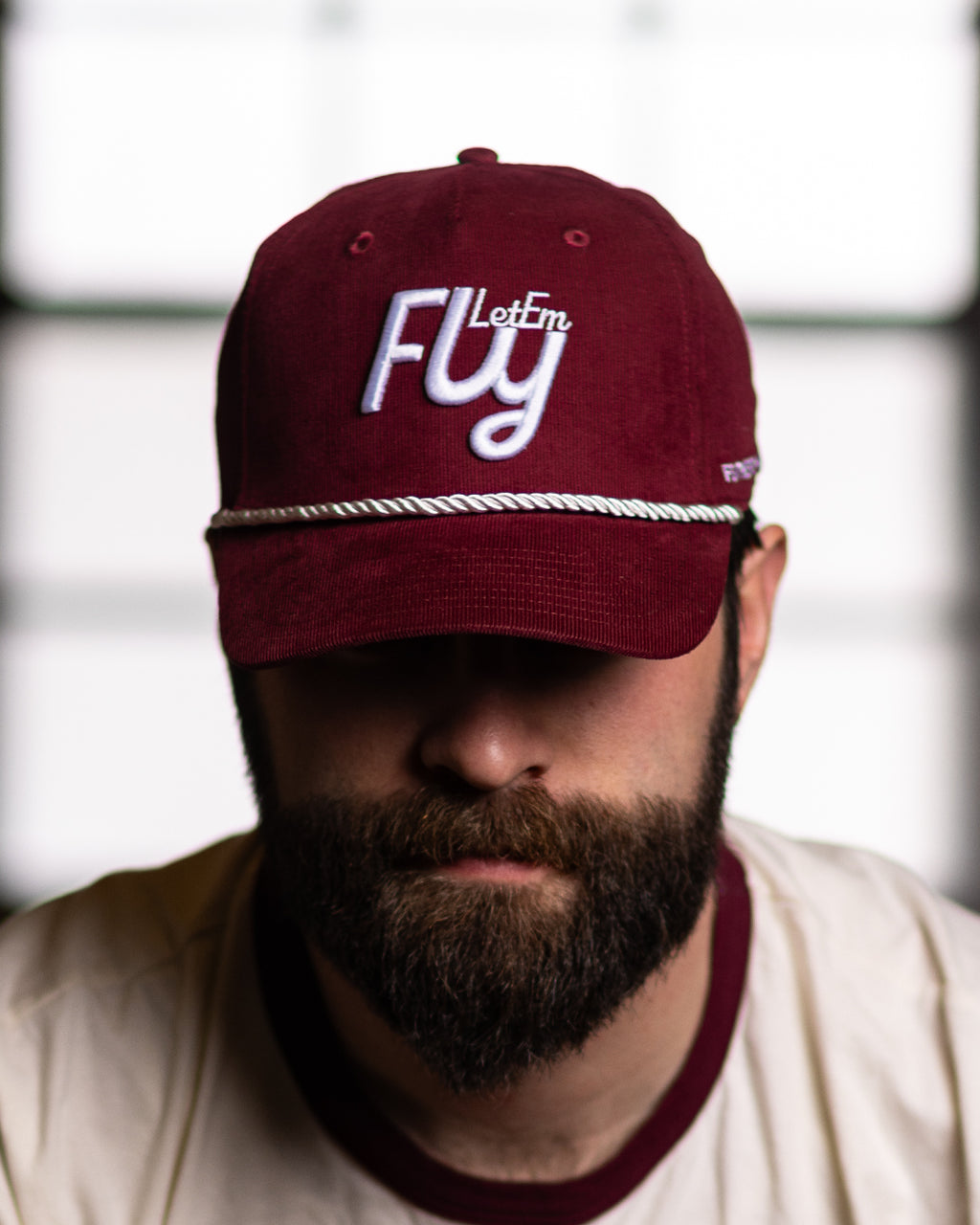 Red corduroy feather and hide golf hat